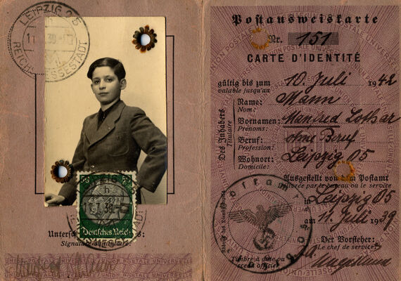 An official document featuring a picture of a child, German writing, typed and handwritten, and stamps, including an ink stamp showing an eagle and a swastika.