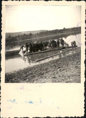 <p>Jews being transferred across the Dniester River in a raft, on their way to Transnistria. Moghilev-Podolski (now Mohyliv-Podilskyi, Ukraine), 1942. </p>
<p><em>Yad Vashem Photo Archive, Jerusalem. 90DO8. </em></p>