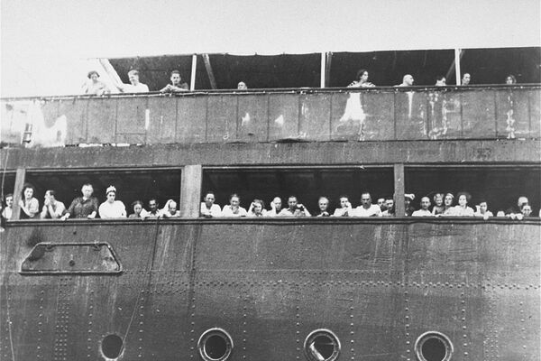 Jewish refugees aboard the MS St. Louis attempt to communicate with friends and relatives in Cuba, who were permitted to approach the docked vessel in small boats. Source: United States Holocaust Memorial Museum, courtesy of National Archives and Records Administration, College Park.