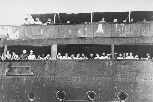 Jewish refugees aboard the St. Louis attempt to communicate with friends and relatives in Cuba, who were permitted to approach the docked vessel in small boats. Source: United States Holocaust Memorial Museum, courtesy of National Archives and Records Administration, College Park.