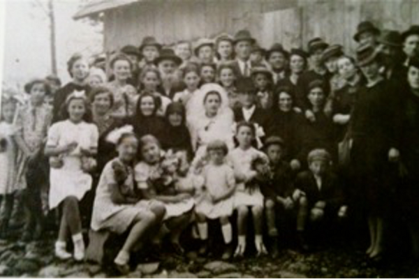 The wedding of Lenka’s cousin, Sarah Fisher. Last row: Dora, Lenka’s sister, is third from the left; Meyer, Lenka’s cousin, is fourth from the left; and Lenka is fifth from the left. Second row: Lenka’s mother, Sarah, is second from the left; Lenka’s grandmother, Rivka, is to the left of the bride. Place unknown, 1941.