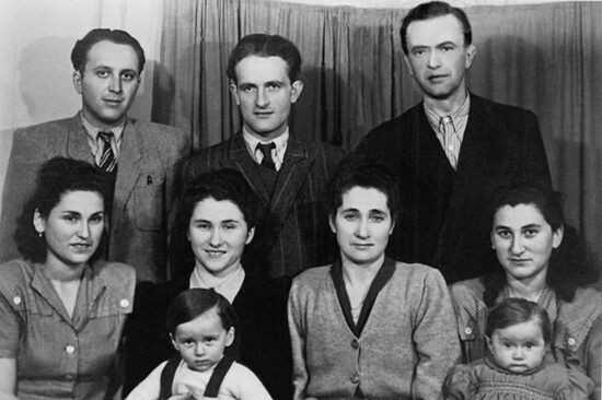Helen’s family after the war. Back row, left to right: Helen’s brother-in-law Mike; her brother-in-law Leibi, and Helen’s husband, Baruch. Middle row, left to right: Helen’s sisters, Brauna, Frieda and Sarah, and Helen. In front, Brauna and Helen’s children. Sighet (now Sighetu Marmației), Romania, 1946.