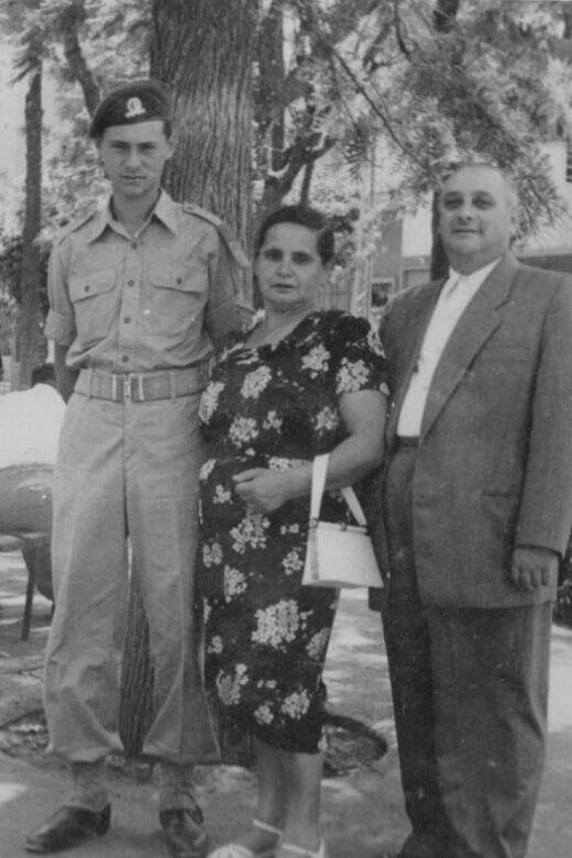 Philip (left), when he served in the Israel Defense Forces, standing with his mother, Iska, and stepfather, Kopel. Israel, circa 1950s.