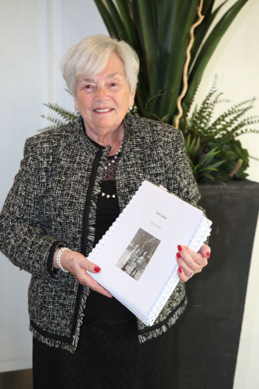 Reny Friedman holding her memoir at the celebration for Sustaining Memories. Toronto, 2017.