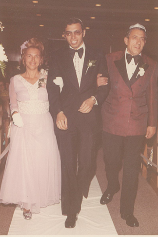 Regina and Chaim walking their son Morris down the aisle at his wedding. Los Angeles, California, 1972.
