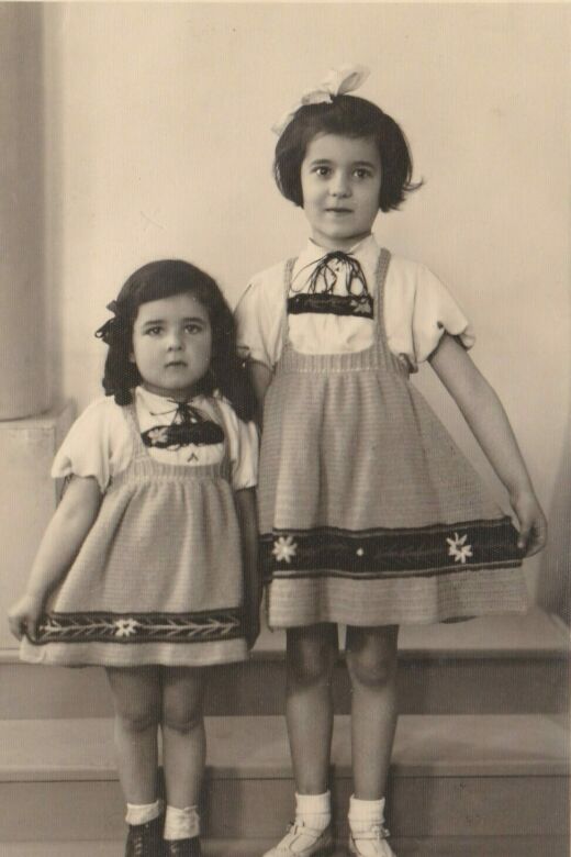 Bracha (right) with her younger sister, Sara, wearing skirts crocheted by their mother. Antwerp, circa 1938.