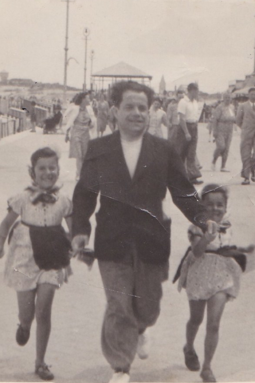 Bracha (left) with her sister Sara and their father on a family vacation, enjoying the day at the beach. Heist-aan-Zee, Belgium, circa 1938.