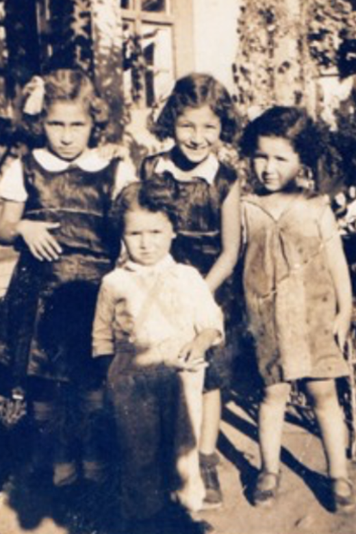 Judit (in back, left) with her sisters Ági (centre) and Anni (right). Their younger brother, Pista, is standing in front. Debrecen, Hungary, date unknown.